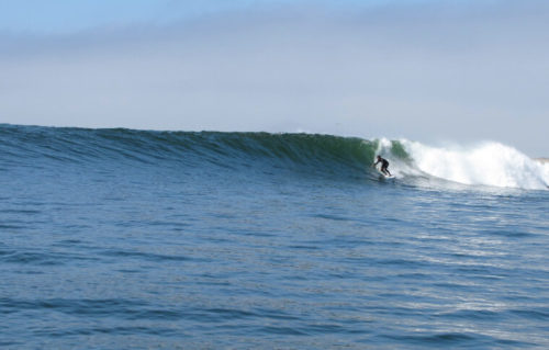 A surfer rides a wave.